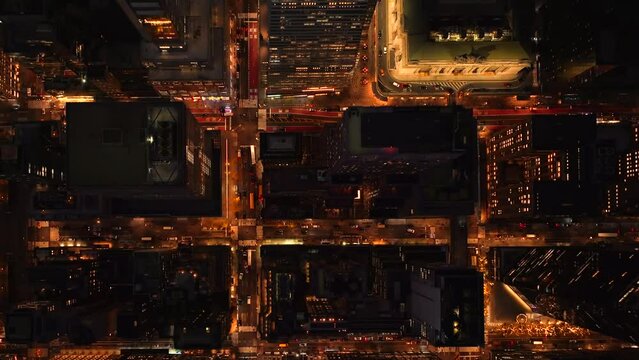 Aerial shot of generic North American featureless urban area. 4k night drone shot of the busy downtown streets