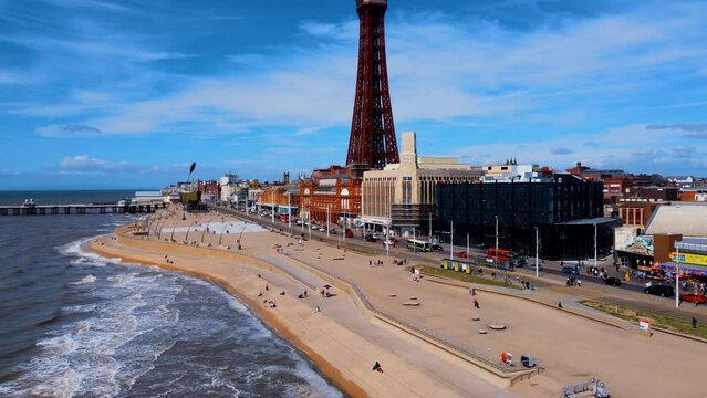 pier overhead view. Birds flying on the Ferris wheel and the pier. Waves crashing on the shore in the blue sea