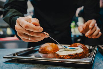 chef hand cooking cheeseburger on restaurant kitchen