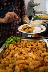 Man take fish fillet food buffet in event