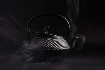 Black japanese cast iron teapot with steam
