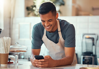 Phone, small business and barista man in cafe shop for networking, online sales management and ecommerce. Happy waiter, cashier or worker person on smartphone, technology application in restaurant