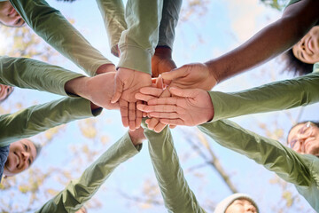 Teamwork, collaboration and low angle of people with hands together for team building. Motivation,...