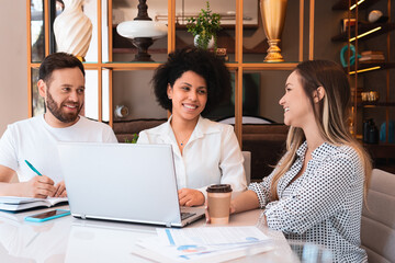 group of friends studying together and sitting at living room table