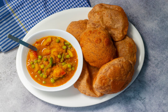 delicious Indian food "Matar ki Sabji aur poori". Green pea potato curry with puri.