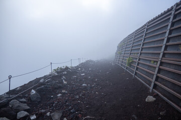 Mt Fuji trail on Fujiyoshida route in a dense fog in Fujiyoshida, Yamanashi, Japan. August 4, 2022