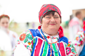 Belarus, the village of Lyaskovichi. August 20, 2022. Festival of ethnic culturesAn old Belarusian or Ukrainian woman in an embroidered shirt. Slavic elderly woman in national ethnic clothes.
