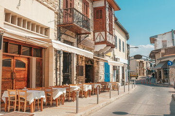 Streets of the old city of Limassol. Blue shutters on the colonial architecture of Cyprus. - obrazy, fototapety, plakaty