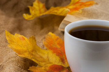 Autumn composition. Cup of coffee, dried leaves background. Autumn elegant concept. Close up