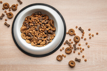 A bowl of dog food on a wooden floor.