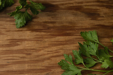 Wooden board with parsley leaves. Rustic backgrounds related to the kitchen, preparation of food at home