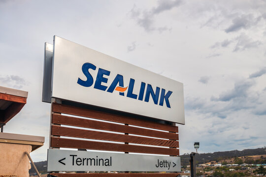 Penneshaw, Kangaroo Island, South Australia - January 17, 2019: SeaLink Ferry Terminal main entrance sign with logo viewed from car park at dusk