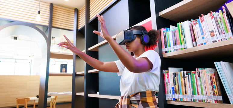 VR Headset Library. Young Teen Girl Student Training And Learning With VR Virtual Teality Headset In School Library.