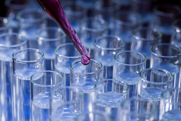 Pipette dropping fluid into test tube
