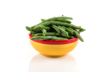 Frozen cut green beans vegetable in a bowl, isolated on white