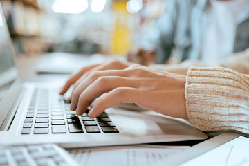 Closeup, student hands and typing on laptop at desk for studying, planning and learning for goals. Man, keyboard and computer for brainstorming and online research for ideas at university library