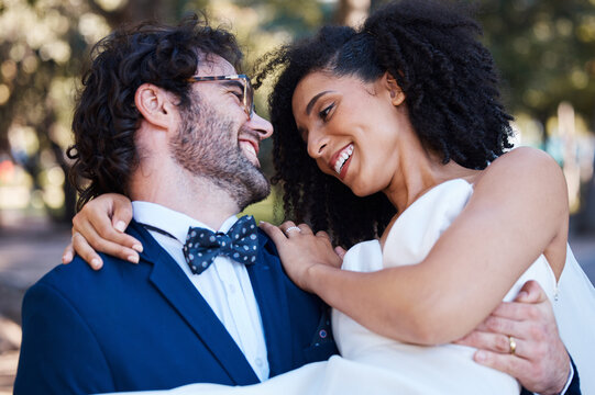 Happy couple, wedding and carrying bride outdoor at marriage celebration event with love. Interracial man carries woman in arms at park for care, partnership and support with a smile while walking - Powered by Adobe