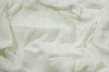 White fabric background. White cloth waves background texture. White fabric cloth textile material.