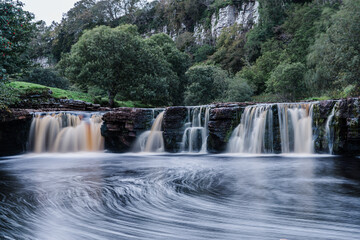 Fototapeta premium Waterfall in the Yorkshire Dales With swirling pools and long exposure to produce blurry out of focus water