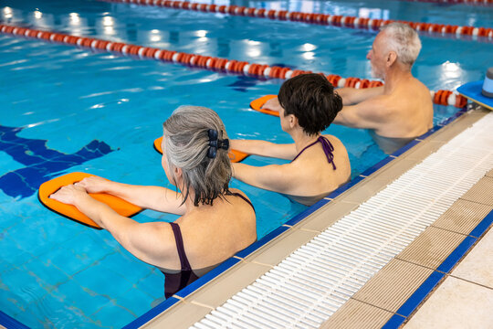 Group Of Seniors Having A Swimming Class At The Swimming Pool