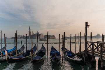 Gondolas docked by the lagoon in Venice, Italy and Saint Giorgio Maggiore in the background
