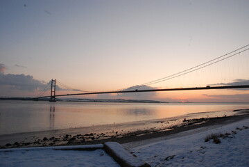 Humber Bridge over the water with a sunset