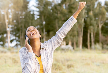 Outdoor, phone call and black woman excited, achievement and happiness with connection, communication and talking. Nature, African American female and lady in forest, cellphone or smile for good news