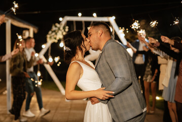 Fototapeta na wymiar newlyweds at a wedding of sparklers