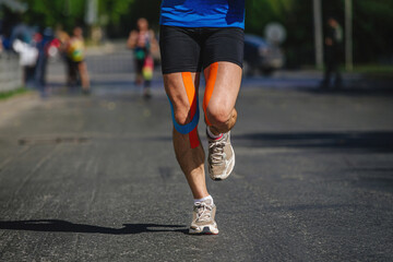 legs runner man with kinesio taping run marathon - obrazy, fototapety, plakaty