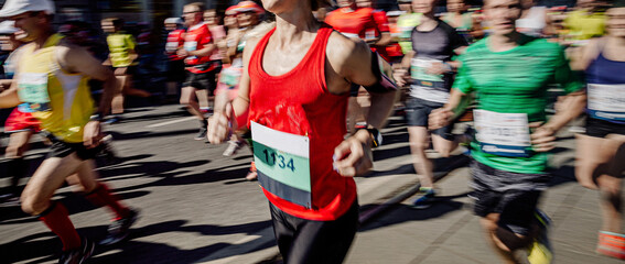 group runners running marathon in motion blur