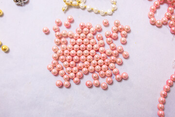 Natural sea pearls. A bunch of pearls on a white background, pearl strands close-up.