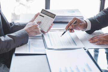 Finance and investment concept, Businessman present business finance investment plan with his partner, Investor colleagues discussing new investment plan by financial graph data on office table