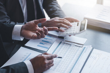 Finance and investment concept, Businessman present business finance investment plan with his partner, Investor colleagues discussing new investment plan by financial graph data on office table