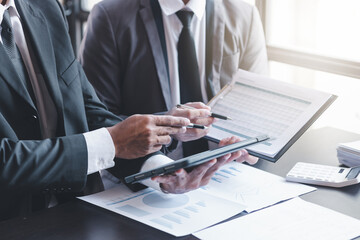 Finance and investment concept, Businessman present business finance investment plan with his partner, Investor colleagues discussing new investment plan by financial graph data on office table