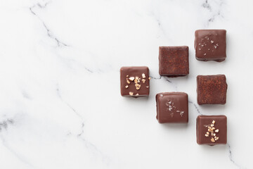 Chocolate bonbons on white marble background