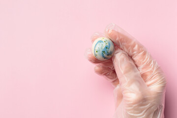 Painted handcrafted chocolate bonbon in a human hand
