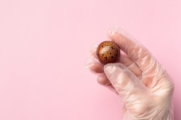 Painted handcrafted chocolate bonbon in a human hand