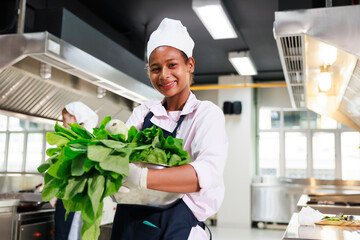 portrait young teen girl cook student. Cooking class. culinary classroom. happy young african woman...