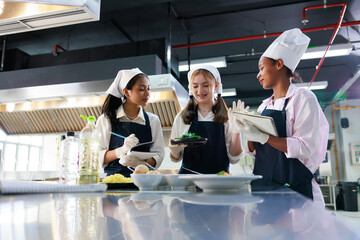 take note on book. Cooking class. culinary classroom. group of happy young woman multi-ethnic...
