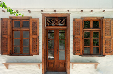 Wooden windows and door of whitewashed building of Naxos, Greece