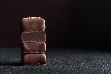 Chocolate bonbons with truffle on black background