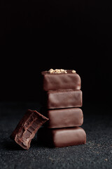 Chocolate bonbons with praline on black background