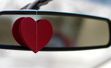 millennial woman in car holding paper typing message or hugging balloon heart sitting in coffee...