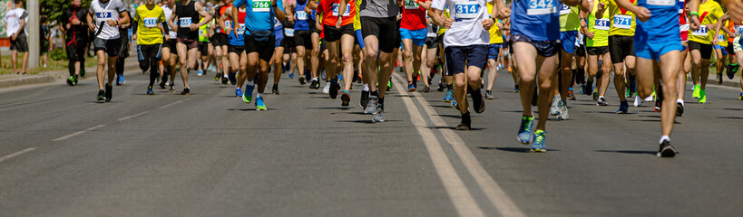 Fototapeta na wymiar large group of leg runners athletes run urban marathon