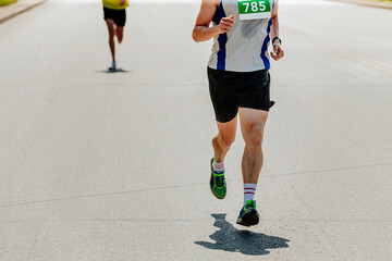 male runner in sweaty tshirt running marathon