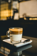 beautiful layer of milk with coffee in the cafe.