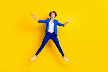 Fototapeta na wymiar Full length photo of shiny adorable woman wear blue jumping high like star isolated yellow color background
