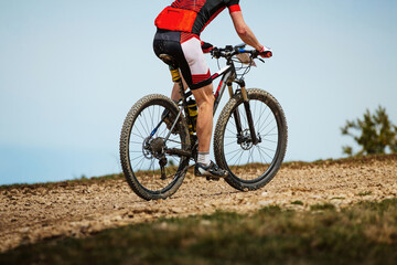 Fototapeta na wymiar male cyclist riding mountain bike uphill