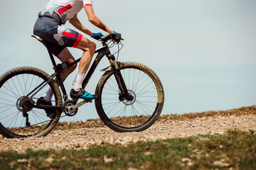 Fototapeta na wymiar athlete cyclist riding mountain bike uphill