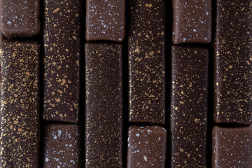 Closeup dark chocolate candies background